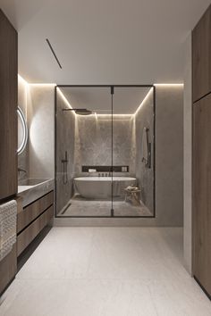 a bathroom with a tub, sink and large mirror in it's center wall