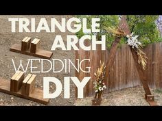 an arch made out of wood with flowers on it and the words triangle arch wedding diy