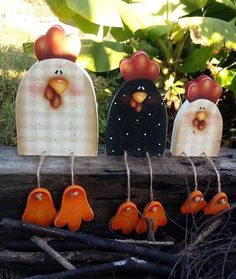 four wooden chickens hanging from clothes pins