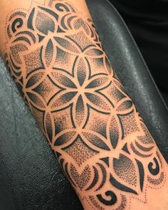 a person with a tattoo on their arm that has an intricate design in the middle