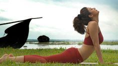 a woman is doing yoga in the grass