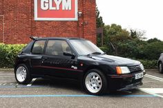 a black car parked in front of a gym