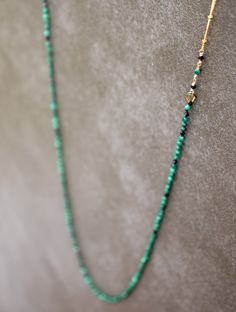 Feels like an energetic hug A stunning statement piece, this necklace feels incredible wear. It features vibrant green malachite beads and black spinel accent beads, hand-knotted in a symmetrical pattern, delicately wire wrapped with a striking 14k gold filled satellite chain. The 30" necklace can can be worn in a multitude of ways, as it does not have a clasp. Malachite is a nourishing stone of enlightened leadership & action, creativity, confidence, and heart healing. Black Spinel is a stone t Handmade Elegant Malachite Beaded Necklaces, Elegant Single Strand Malachite Jewelry, Elegant Green Malachite Beaded Necklace, Elegant Beaded Malachite Necklaces, Green Hand-strung Long Necklace, Loop Necklace, Symmetrical Pattern, Heart Healing, Green Malachite