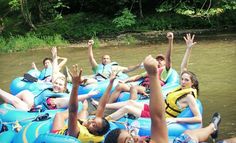 a group of people riding on the back of an inflatable raft