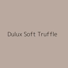 the words dulux soft truffle on a gray background