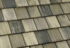 a close up view of a tile roof with different shades of gray and white tiles