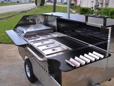 an outdoor bbq grill on the side of a road