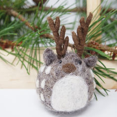 a close up of a stuffed animal with antlers on it's head and nose