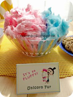 there is a bowl full of colorful cotton floss next to a sign that says it's so fluffy