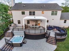 an aerial view of a house with a hot tub and patio area in the foreground