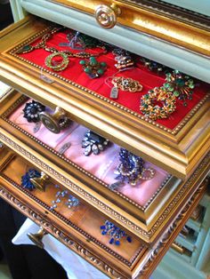 an old dresser with jewelry on it