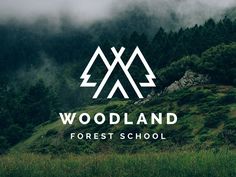 the woodland forest school logo is shown in front of some trees and mountains with clouds