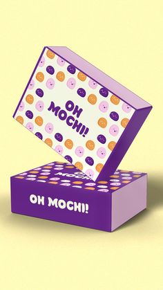 an open purple box with donuts on it that says oh moschi in the middle