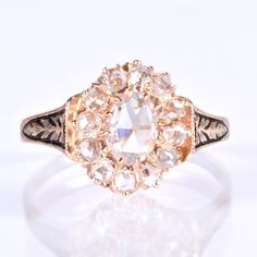 an antique diamond ring is shown on a white surface