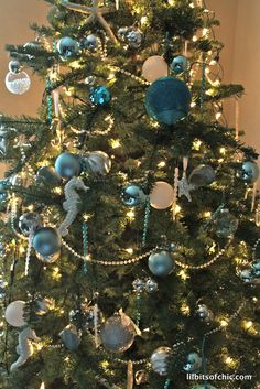 a christmas tree decorated with blue and silver ornaments