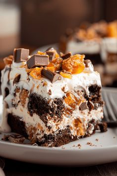 a piece of cake on a white plate with chocolate chips and oranges around it