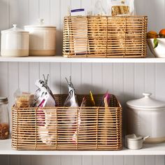 two wicker baskets on top of shelves with food and utensils in them