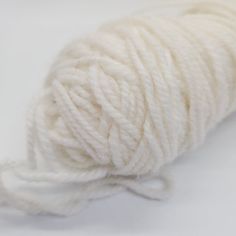 a skein of white yarn on a white surface