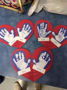 three heart shaped handprints with two hands on them