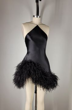 Fin  Black silk sueded satin backless halter, tapered neckline suspended by dainty satin cord. Asymmetrical hem embroidered with custom dyed pure ostrich feathers. Invisible zipper at center back.    Color and length may be customized. May be paired with custom designed sleeves and gloves. FAQS HOW LONG DOES THE PROCESS TAKE? Each look is custom made to order with precise measurements. Ideally requiring a minimum of 8 weeks.  If faster delivery is needed, a priority reservation can be placed with this listing: https://www.etsy.com/listing/1606891070/priority-reservation WHAT MEASUREMENTS ARE REQUIRED?  Your unique measurements are the most important part of the process. These measurements will be needed to begin work on your garment. * BUST (Around the fullest part of the chest, including Black Sequin Cocktail Dress, Waist Drop Dress, Satin Birthday Outfit, Edgy Cocktail Attire, Black Salsa Dress, Custom Made Birthday Dress Black Women, Black Dress High Fashion, Velour Clothes, Dress To Wear To A Wedding As A Guest