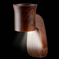 a wooden light fixture on a black background