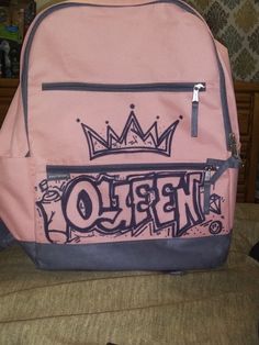 a pink backpack with the word hello written on it and a crown in the middle