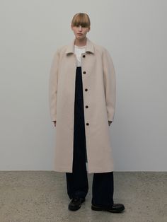 Editor's NotesThis is an oversized balmacaan coat with a maxi length. The shoulders are padded to give volume, and it features a mock collar. The first button of the closure is exposed, while the others are hidden for a clean silhouette.- Can adjust the sleeves and collar with toggles to suit your style- Signature overdueflair seam lines and an out label on the back as a refined touch- A pocket on the inside for added practicality- Horn buttons with the logo engraved adding to the quality* A det Long Coat Outerwear With Covered Buttons For Work, Long Coat With Covered Buttons For Work, Long Coat With Covered Buttons For Fall, Fall Long Coat With Covered Buttons, Classic Oversized Outerwear With Stand Collar, Oversized Long Wool Coat With Button Closure, Modern Oversized Outerwear With Button Closure, Oversized Long Coat With Hidden Button Closure, Oversized Beige Outerwear With Hidden Buttons