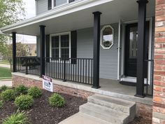 the front porch of a house with a for sale sign