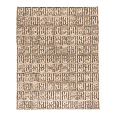 a beige and brown rug with an intricate design on the bottom, in front of a white background