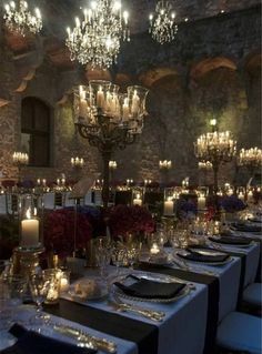 a long table is set with candles and place settings for an elegant dinner or party