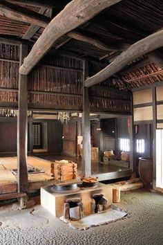 the inside of an old japanese house with wood flooring and wooden beams on the ceiling