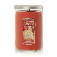 yankee candle jar filled with cinnamon apple flavored cookies and whipped cream, on a white background