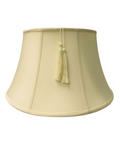 a lamp shade with a tassel hanging from it