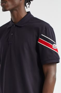 A stripe-emblazoned sleeve brings the label's signature colors to a polished polo fashioned from comfortable cotton. Button half placket Cutaway collar Elbow-length sleeves 100% cotton Machine wash, dry flat Imported Designer Clothing Cotton Polo Shirt With Striped Cuffs, Cotton Polo Shirt With Three Stripes Branding, Cotton Polo Shirt With Three Stripes And Collar, Cotton Collared Polo Shirt With Three Stripes Branding, Casual Collared Polo Shirt With Striped Cuffs, Cotton Striped Collared Polo Shirt, Designer Cotton Tops With Striped Collar, Navy Polo Shirt With Striped Collar For Work, Navy Striped Collar Polo Shirt For Workwear