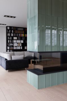 a living room with bookshelves and couches in front of a book shelf