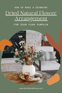 a vase filled with flowers sitting on top of a table next to a white pumpkin