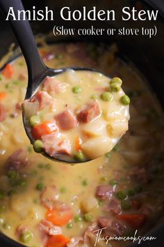 a spoon full of soup with peas, ham and carrots in it's crock pot