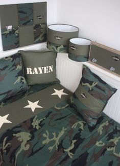 a bed room with camo sheets and pillows