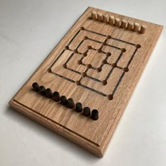 a wooden board with several pegs on it