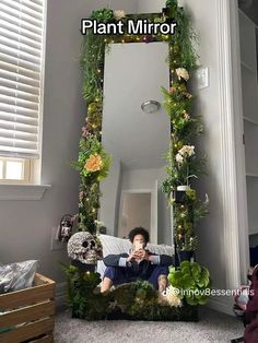 a man is taking a selfie in front of a mirror decorated with plants and flowers