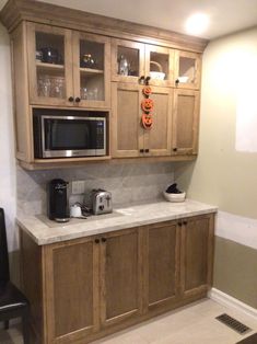 a kitchen with wooden cabinets and white counter tops