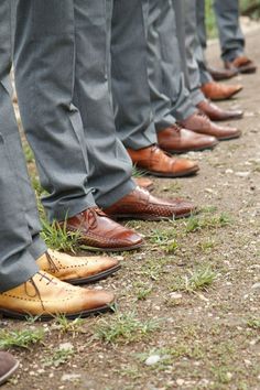 a row of men's dress shoes lined up on the ground