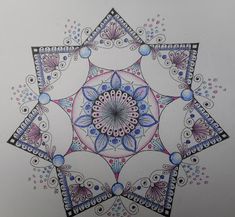 a drawing of an intricate design on paper