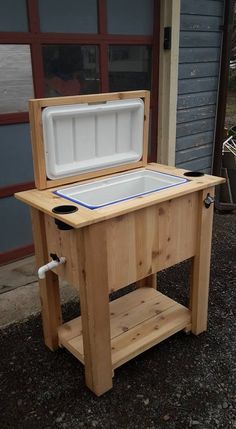 an ice chest sitting on top of a wooden table