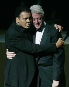 two men in tuxedos embracing each other