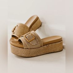 Introducing The Natural Raffia Platform Slide Sandals. With An Adjustable Buckle And Easy Slip On Design, These Sandals Provide A Comfortable And Convenient Fit. The Raffia Texture Adds A Unique Touch, While The 2.5 Inch Platform Offers Added Height And Support. Perfect For Any Summer Boho Outfit. Buckle Slip On Raffia Texture About A 2.5 Inch Platform #Slide Platform Sandal, Summer Sandals, Platforms, Raffia Sandals, Beach Sandals, Boho, Western, Tan Platform, Nude Sandals, Mules, New, Platform Summer Wedge Sandals With Buckle Closure, Slip-on, Beach Slip-on Wedge Sandals With Buckle Closure, Slip-on Wedge Sandals With Buckle Closure For Beach, Summer Straw Wedge Sandals With Textured Footbed, Vacation Wedge Sandals With Buckle Closure And Round Toe, Beige Buckle Closure Wedge Sandals For Summer, Brown Straw Flat Sandals, Brown Flat Straw Sandals, Brown Summer Wedge Sandals In Synthetic