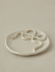 a white plate with an abstract design on it