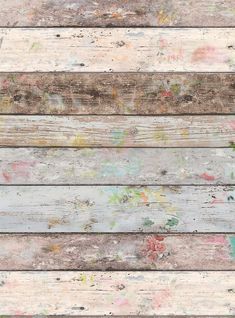 an old wooden plank wall with paint splattered on the wood and flowers painted on it