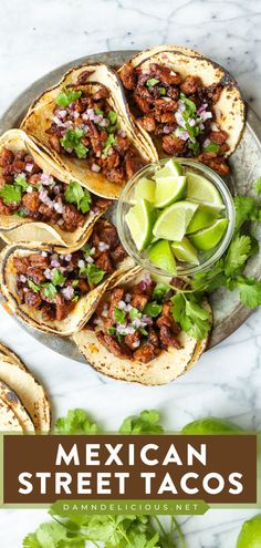 mexican street tacos with limes and cilantro on the side, along with tortillas