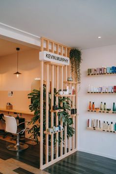 the interior of a salon with shelves and plants